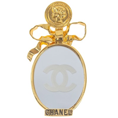 Lot 605 - A Chanel gold-tone mirror brooch.