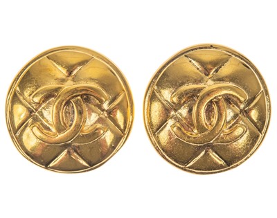 Lot 630 - A Chanel pair of gold-tone CC quilted circular clip earrings.