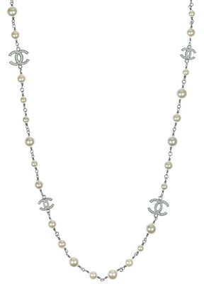 Lot 554 - A Chanel white metal cultured pearl and white gem set CC long necklace.