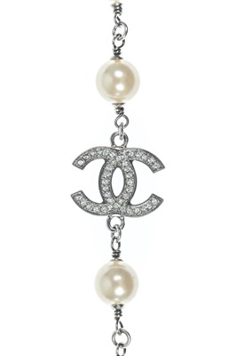 Lot 554 - A Chanel white metal cultured pearl and white gem set CC long necklace.