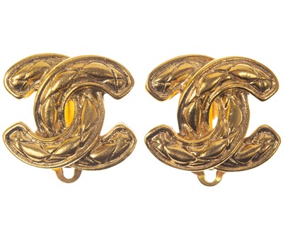 Lot 580 - A Chanel pair of CC quilted gold-tone clip earrings.