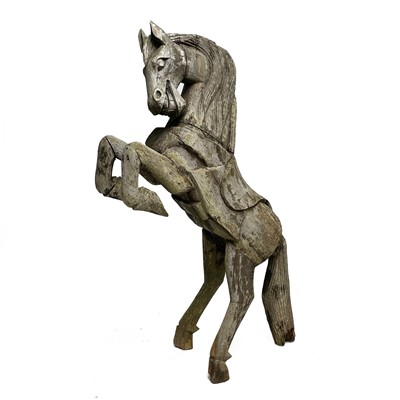 Lot 278 - A large wood carved sculpture of a free standing rearing horse.