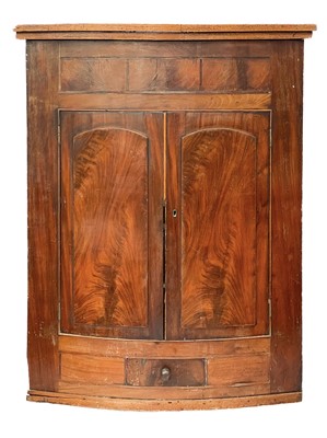 Lot 380 - A George III mahogany wall hanging corner cupboard.