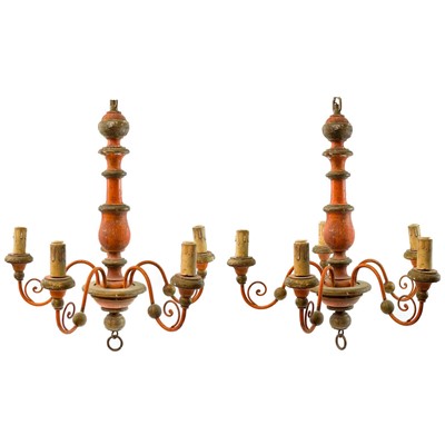 Lot 28 - A pair of painted and gilt wood five branch chandeliers.