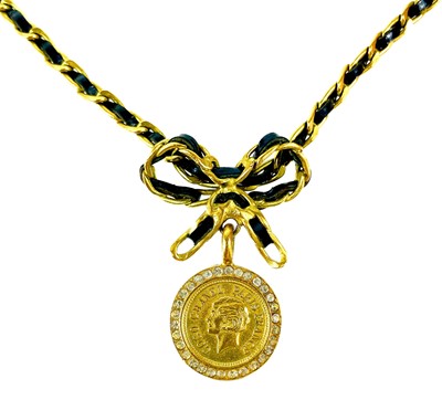 Lot 8 - A Chanel Barbie Collection gold-tone and leather thong crystal set pendant necklace.