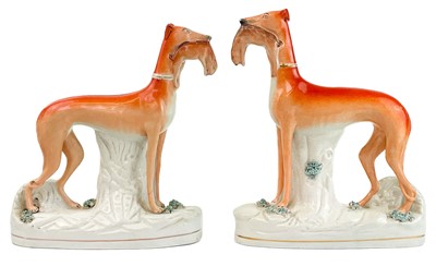 Lot 2 - A pair of Victorian Staffordshire figures of greyhounds.