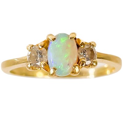 Lot 333 - A 14ct white opal and diamond three-stone ring.