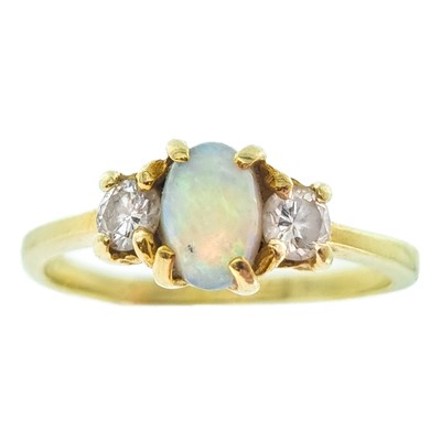 Lot 112 - A 14ct white opal and diamond three-stone ring.