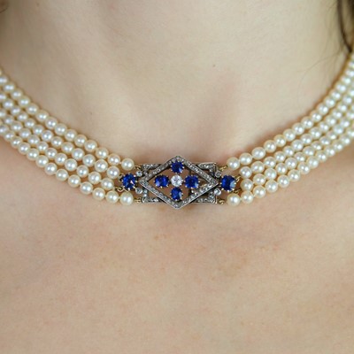 Lot 70 - An exquisite Art Deco four-row natural saltwater pearl choker with diamond and sapphire clasp.