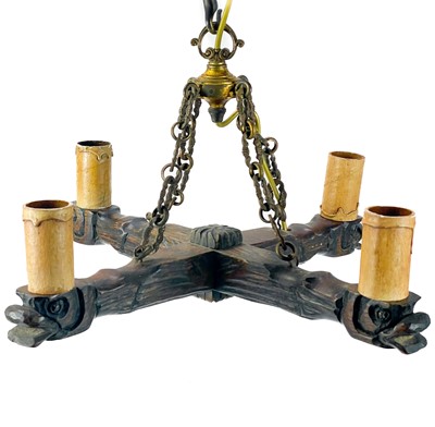 Lot 119 - A carved wood four branch electrolier.