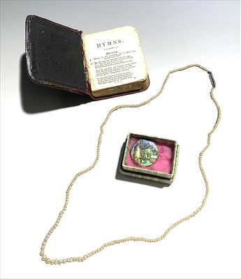 Lot 2447 - A seed pearl necklace, a silver mounted prayer...