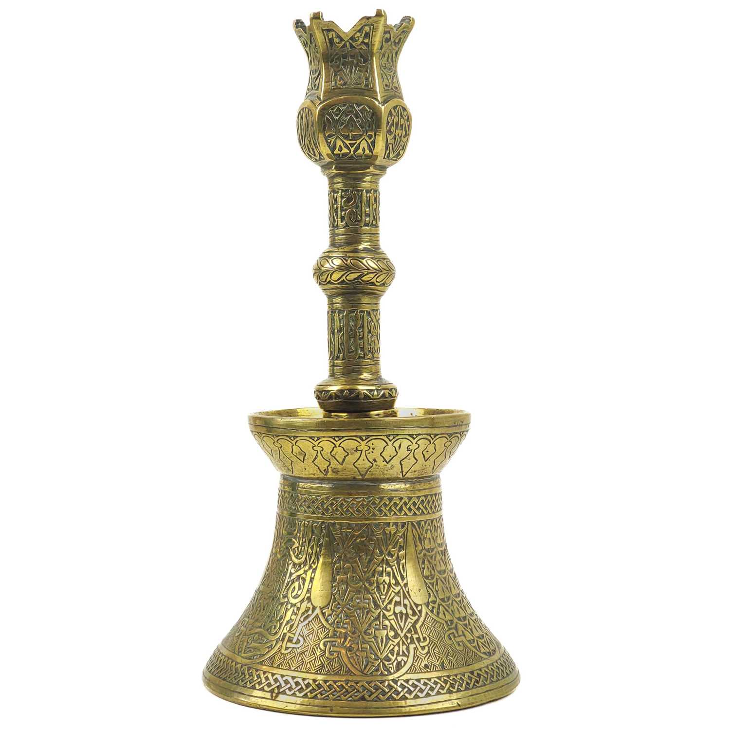 Lot 4 - A Persian engraved brass candlestick, Qajar, 19th century.