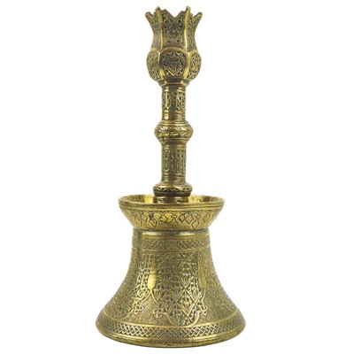 Lot 4 - A Persian engraved brass candlestick, Qajar, 19th century.
