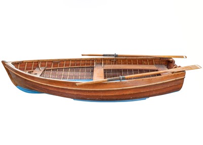 Lot 129 - A 10ft teak clinker built row boat.