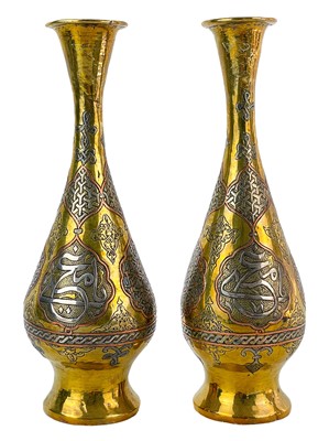 Lot 14 - A pair of Cairoware brass and silver inlaid vases, Egypt, 19th century.