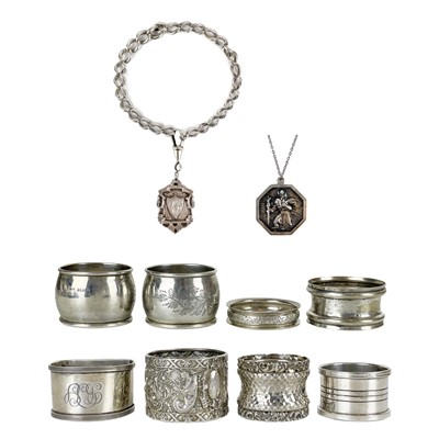 Lot 200 - A selection of six silver napkin rings, a shield fob, curb chain and a pendant necklace.