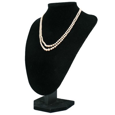 Lot 38 - A double-strand graduated cultured pearl necklace with three-stone diamond clasp.