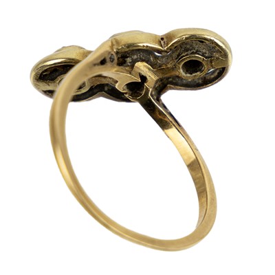 Lot 10 - An early 20th century gold diamond set three-stone crossover ring.