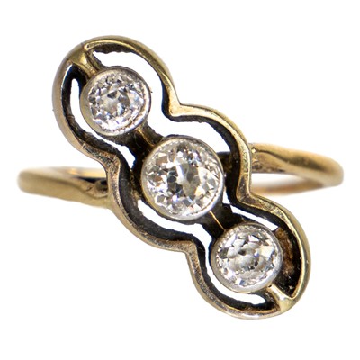 Lot 10 - An early 20th century gold diamond set three-stone crossover ring.