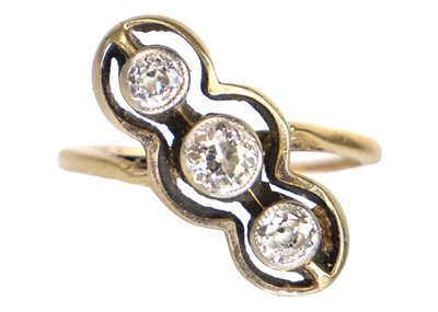 Lot 133 - An early 20th century gold diamond set three-stone crossover ring.