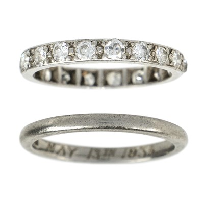 Lot 196 - A platinum diamond set full eternity ring and a platinum band ring.