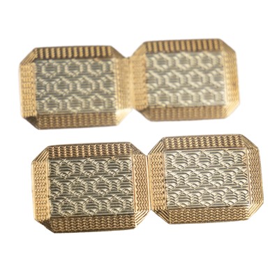 Lot 363 - A pair of 9ct white and yellow gold engine turned cufflinks.