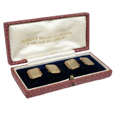 Lot 363 - A pair of 9ct white and yellow gold engine turned cufflinks.