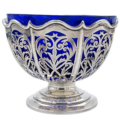 Lot 119 - An Edwardian silver sugar bowl with blue glass liner by James Deakin & Sons.