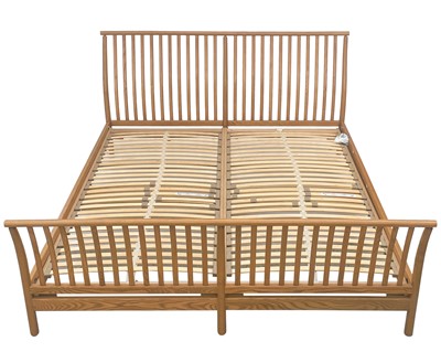 Lot 449 - An Ercol light elm super king size bed.