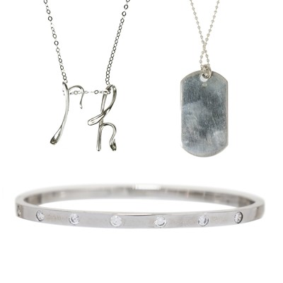 Lot 424 - A silver bangle, dog tag and pendant necklace.