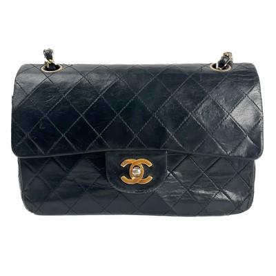 Lot 570 - A Chanel black lambskin quilted medium double flap bag, 23cm, circa 1986-1988.