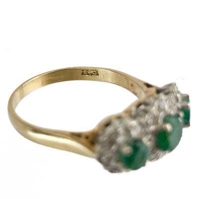 Lot 44 - An 18ct gold emerald and diamond triple cluster ring.