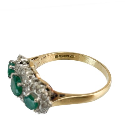 Lot 44 - An 18ct gold emerald and diamond triple cluster ring.