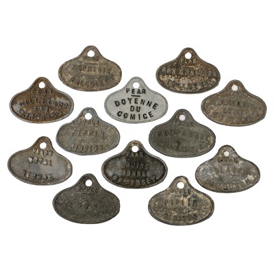Lot 7 - A collection of 12 cast metal fruit store labels.