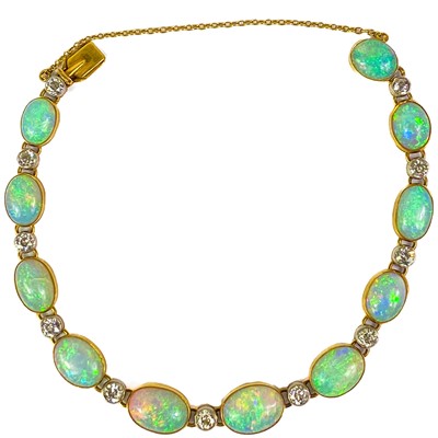 Lot 94 - An attractive early 20th century gold, diamond and blue opal set bracelet.