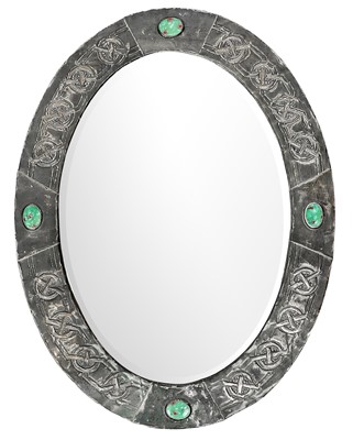 Lot 10 - An Arts and Crafts oval pewter mirror.