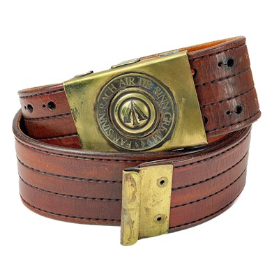 Lot 221 - A handmade leather cartridge belt with attached gun holster.