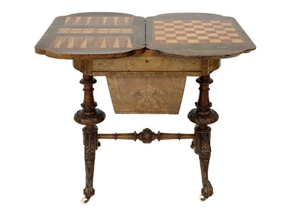 Lot 418 - A Victorian burr walnut games and sewing quatrefoil table with boxwood inlay.