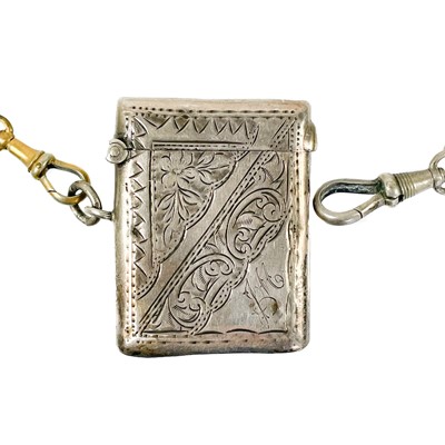 Lot 99 - A silver Albert watch chain applied with two charms and a fob vesta.