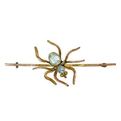 Lot 72 - A 9ct gold pale blue stone set spider bar brooch.
