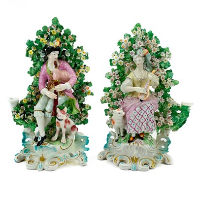 Lot 223 - A pair of Derby porcelain bocage candlestick figures.