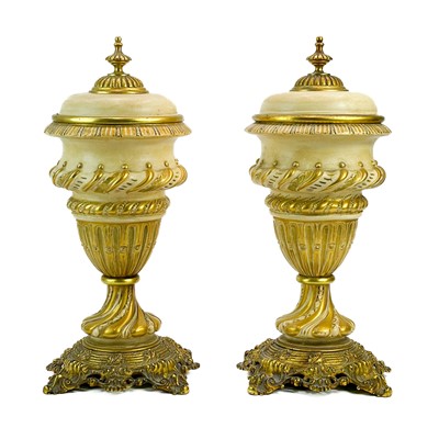 Lot 248 - A pair of Continental porcelain and gilt metal mounted urns and covers.