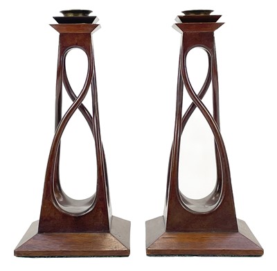 Lot 88 - A pair of Arts and Crafts mahogany carved candle holders.