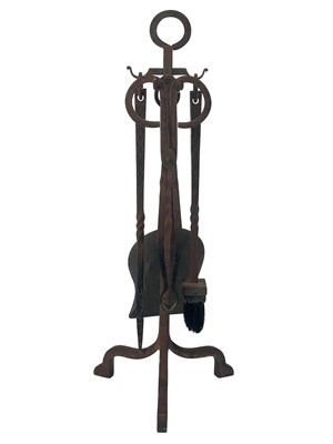 Lot 180 - An Archibald Carne, Truro wrought iron companion set.