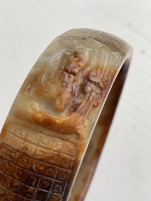 Lot 22 - A Chinese carved jade bangle, probably Neolithic period.