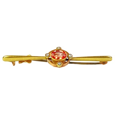 Lot 263 - An Edwardian peach sapphire, possibly Padparadscha, and seed pearl set bar brooch.