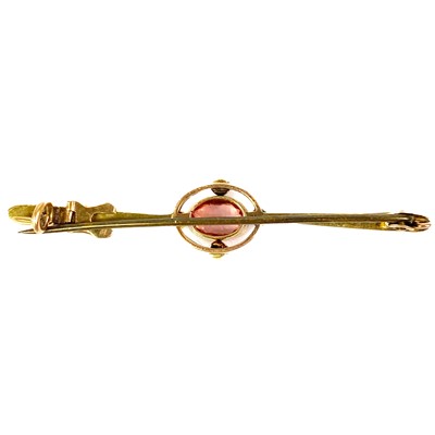Lot 263 - An Edwardian peach sapphire, possibly Padparadscha, and seed pearl set bar brooch.