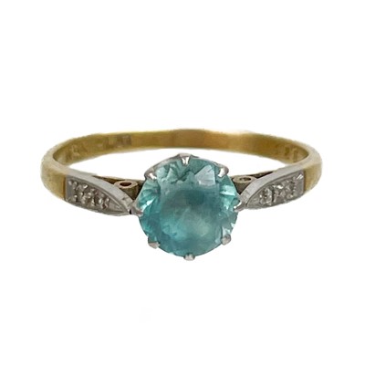 Lot 59 - An 18ct and platinum blue topaz and diamond set solitaire ring.
