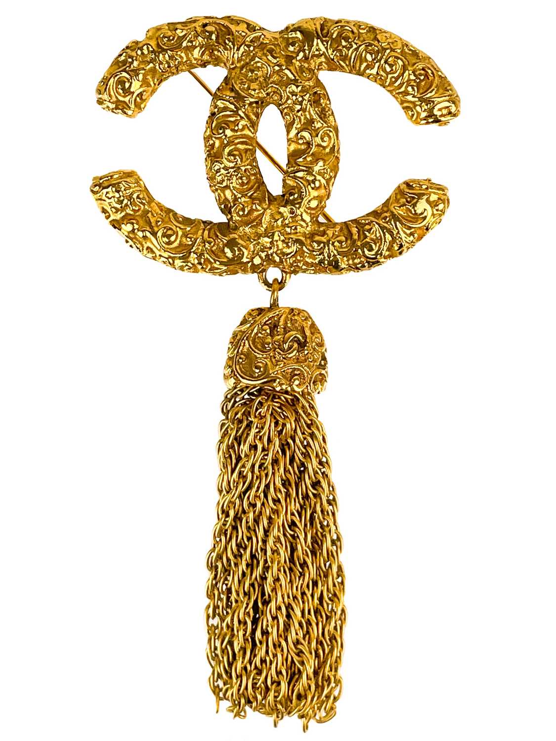 Lot 488 - A Chanel 24ct gold-plated CC lava collection tassel brooch, circa 1993.