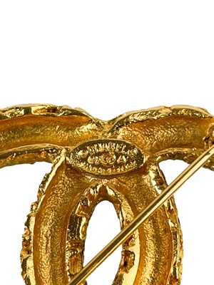 Lot 488 - A Chanel 24ct gold-plated CC lava collection tassel brooch, circa 1993.